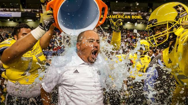 Bishop Gorman High football coach Tony Sanchez was drenched with water after coaching the West to a win in the U.S. Army All-American Bowl in San Antonio.