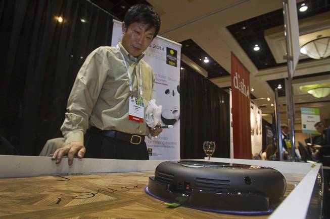 Jong Soo Kim gives a demonstration of Moneual's Rydis H68 Pro Hybrid Robot Vacuum during "CES Unveiled," a media preview event to the annual Consumer Electronics Show (CES), in Las Vegas, Jan. 5, 2014. The robot can vacuum, wet-mop floors and uses smart vision technology to map out floor plans.