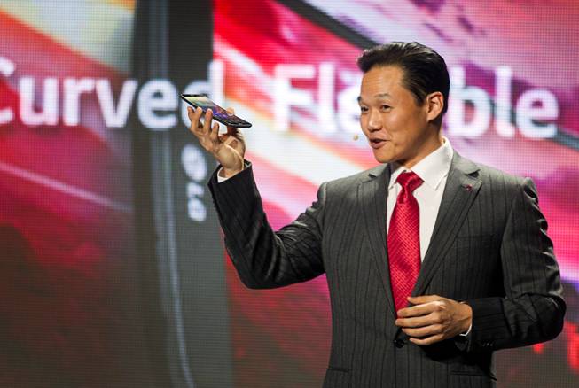 Frank Lee, head of mobile communications for LG Electronics USA, holds a curved G Flex smartphone by LG  during the 2014 International Consumer Electronics Show (CES) in Las Vegas, Monday Jan. 6, 2014.