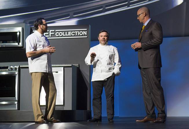 Chefs Christopher Kostow (L) and Michel Troisgros talk with Kevin Dexter, senior vice president of Samsung Electronics America, about the Chef Collection of kitchen appliances during the International Consumer Electronics Show (CES), in Las Vegas, Monday Jan. 6, 2014.
