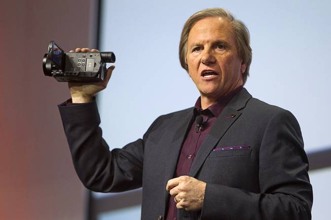 Mike Fasulo, president and COO of Sony Electronics Inc., holds a Sony FDR-AX100 4K camcorder during a Sony news conference at the International Consumer Electronics Show (CES), in Las Vegas, Monday Jan. 6, 2014. The camcorder is expected to retail for $2000.00, he said.