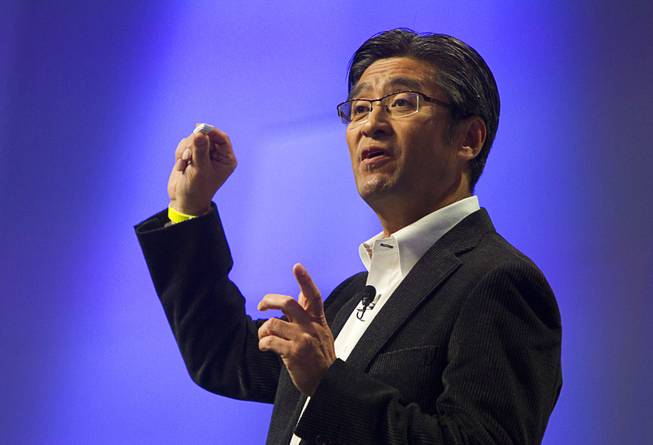 Kunimasa Suzuki, president/CEO of Sony Mobile Communications, holds a Sony Core during a Sony news conference at the International Consumer Electronics Show (CES), in Las Vegas, Monday Jan. 6, 2014. The wearable device will be able to record data about your activities and movement and display the information in a LifeLog app.