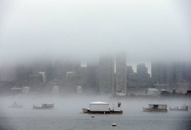 Fog shrouds Boston Harbor and obscures the skyline, Monday, Jan. 6, 2014, in Boston. After a severe winter storm on Friday and days of freezing temperatures in the Boston area, rain was in the forecast for Monday with temperatures reaching into the 50s. 