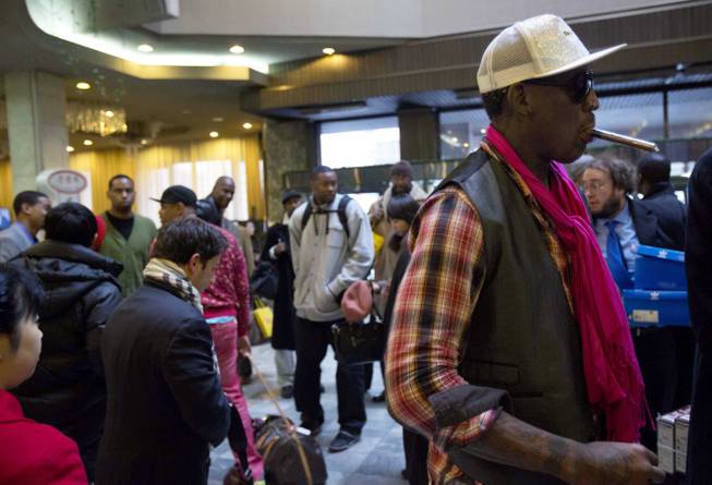 Former NBA basketball star Dennis Rodman, right, and fellow U.S. basketball players arrive at a hotel in Pyongyang, North Korea Monday, Jan. 6, 2014. Rodman arrived in the North Korean capital with a squad of former basketball stars in what he calls "basketball diplomacy," although U.S. officials have criticized his efforts.