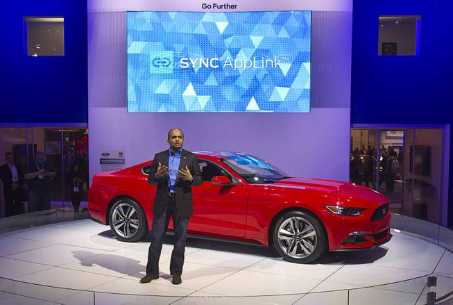 Raj Nair, Ford Motor Company's group vice president of global product development,  speaks in front of a 2015 Ford Mustang during the 2014 International Consumer Electronics Show (CES) at Las Vegas Convention Center in Las Vegas, Tuesday Jan. 7, 2014. The new Mustang will be the first model in North America to feature the enhanced Ford SYNC AppLink system. The improvements include better voice control and simpler menus, a representative said.