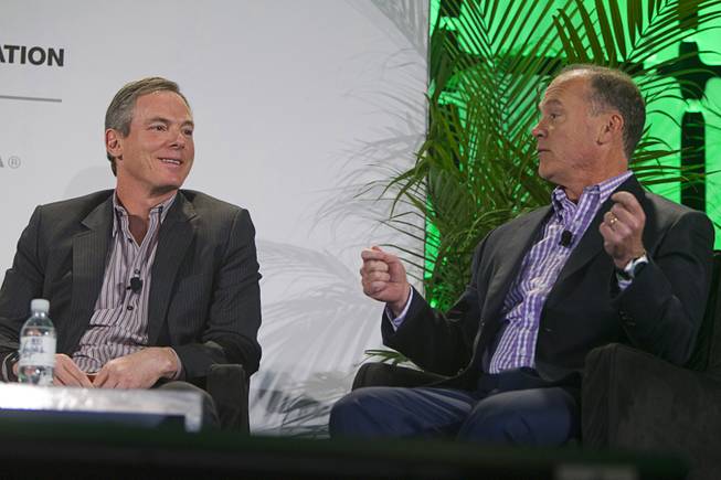 Paul Jacobs (L), chairman and CEO of Qualcomm, listens to John Donovan, senior vice president of technology and network operations for AT&T, during a panel discussion at the 2014 International Consumer Electronics Show (CES) in Las Vegas, Tuesday Jan. 7, 2014.