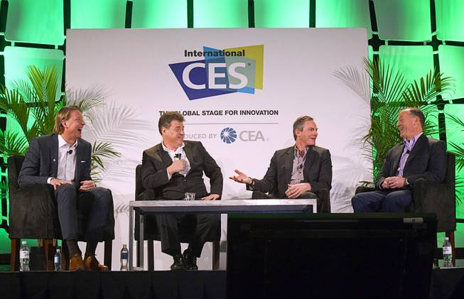 Panelists (L-R) Hans Vestberg, president/CEO of Ericsson Group, moderator Andrew Keen, Paul Jacobs, chairman and CEO of Qualcomm, and John Donovan, senior vice president of technology and network operations for AT&T, prepare for a discussion on the "Global Innovation of Mobile" at the 2014 International Consumer Electronics Show (CES) in Las Vegas, Tuesday Jan. 7, 2014.