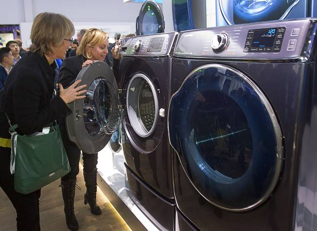 Kate Bulkley (L) and Susan Brazer look over the Samsung Electronics 9000 Series washer and dryer during the 2014 International Consumer Electronics Show (CES) in Las Vegas, Tuesday Jan. 7, 2014. The washer and dryer are the world's largest Samsung says.