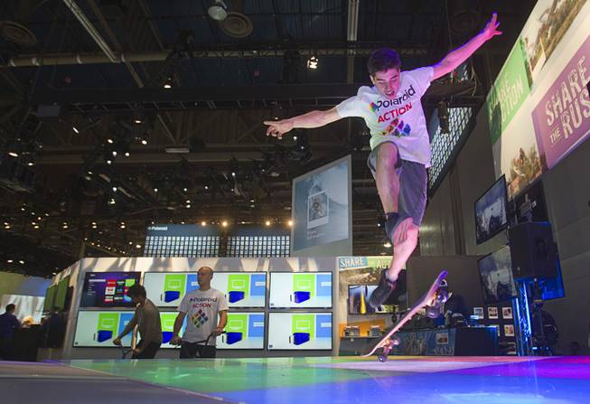 Skateboarder Peter Betti, 18, a member of the Polaroid Action team, performs at the Polaroid booth during the 2014 International Consumer Electronics Show (CES) in Las Vegas, Tuesday Jan. 7, 2014.