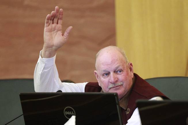 Commissioner Tom Collins raises his hand to make a motion during a meeting of the Las Vegas Valley Water District Board Tuesday, Jan. 7, 2014.