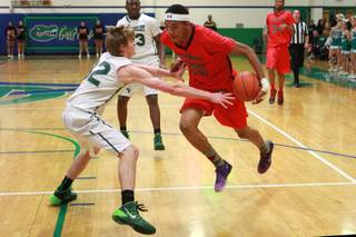 Las Vegas forward Tyler Bey prepares to drive past Green Valley forward Troy Cropper during their game Tuesday, Jan. 7, 2014.