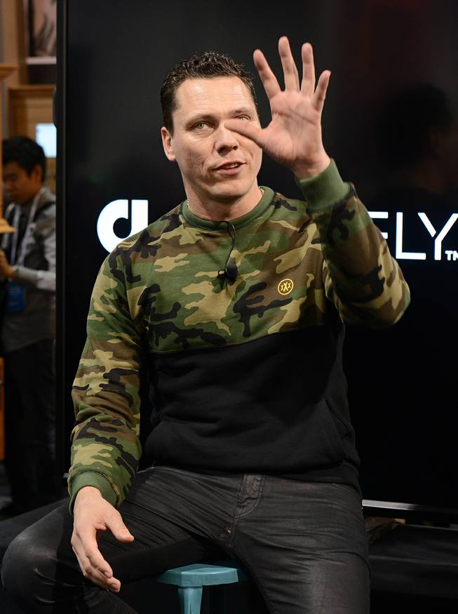 DJ Tiesto holds a press conference at the Audiofly booth to announce the Club Life by Tiesto line of in-ear headphones during the International Consumer Electronics Show on Tuesday, Jan. 7, 2014, in Las Vegas.