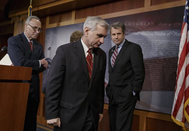 Sen. Jack Reed, D-R.I., center, joined by Sen. Charles Schumer, D-N.Y., left, and Sen. Sherrod Brown, D-Ohio, right, leaves a news conference on Capitol Hill in Washington, Tuesday, Jan. 7, 2014, after legislation to renew jobless benefits for the long-term unemployed unexpectedly cleared an initial Senate hurdle.