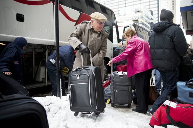 Passengers unload their luggage after arriving at Union Station after their Amtrak train from Los Angeles became stuck in snow drifts on Tuesday, Jan. 7, 2014, in Chicago. The severe weather forced hundreds of Amtrak passengers to spend the night onboard three trains stranded due to the snow in northern Illinois.