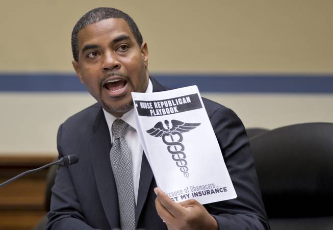 Rep. Steve Horsford, of Nevada, a Democratic member of the House Oversight Committee, holds a document called the House Republican playbook, which he waved in the direction of the GOP side of the committee during a hearing on the problems with implementation of the Affordable Care Act healthcare program, on Capitol Hill in Washington, Wednesday, Nov. 13, 2013. 