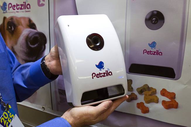 A Petzi Connect is displayed in the Petzila booth during the 2014 International Consumer Electronics Show (CES) in Las Vegas, Jan. 8, 2014. The Internet-enabled device lets pet owners remotely interact with their pets, take photos and video, and dispense treats. The device is expected to retail for $169.00 and be available in March 2014.