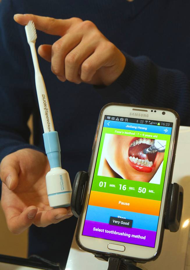 A Mombrush system by Xiusolution of Korea is displayed during the 2014 International Consumer Electronics Show (CES) in Las Vegas, Jan. 8, 2014. The wireless device attaches to a toothbrush and uses a smartphone app to encourage proper brushing behavior.