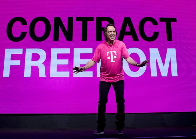 T-Mobile CEO John Legere announces "Contract Freedom" during a news conference at the 2014 International Consumer Electronics Show (CES) in Las Vegas, Jan. 8, 2014. Legere said T-Mobile will pay Early Termination Fees (ETF) for families who transfer service from AT&T, Verizon, and Sprint.