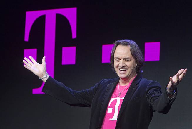 T-Mobile CEO John Legere speaks during a news conference at the 2014 International Consumer Electronics Show (CES) in Las Vegas, Jan. 8, 2014. T-Mobile announced they will pay Early Termination Fees (ETF) for families who transfer service from AT&T, Verizon, and Sprint.