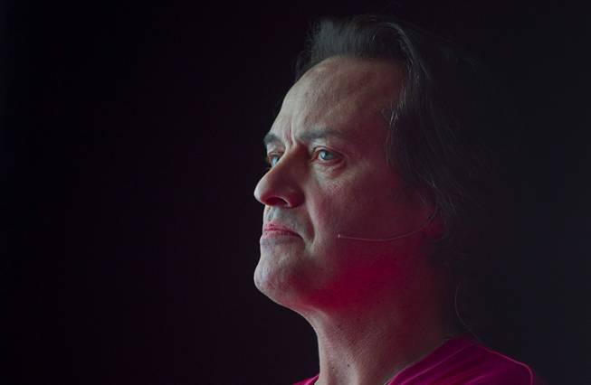 T-Mobile CEO John Legere waits as a video is played during a news conference at the 2014 International Consumer Electronics Show (CES) in Las Vegas, Jan. 8, 2014. T-Mobile announced they will pay Early Termination Fees (ETF) for families who transfer service from AT&T, Verizon, and Sprint.