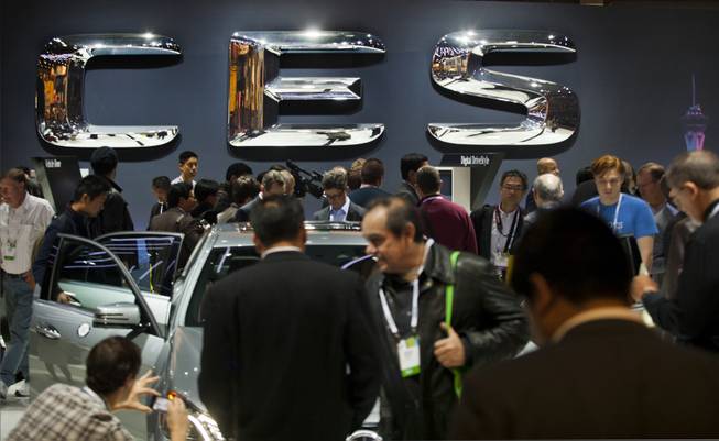 CES attendees swarm over the new Mercedes products on display at the Las Vegas Convention Center on Wednesday, Jan. 8, 2014.