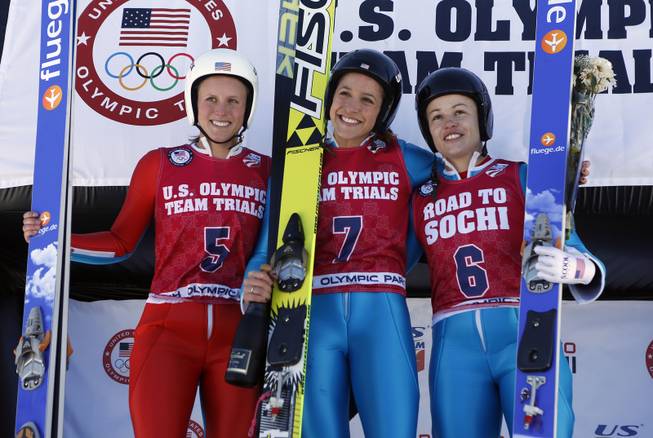 First-place finisher Jessica Jerome, center, second-place finisher Lindsey Van, left, and third-place finisher Alissa Johnson, right, smile on the podium after the women's ski jumping event at the U.S. Olympic trials in Park City, Utah, Sunday, Dec. 29, 2013. 