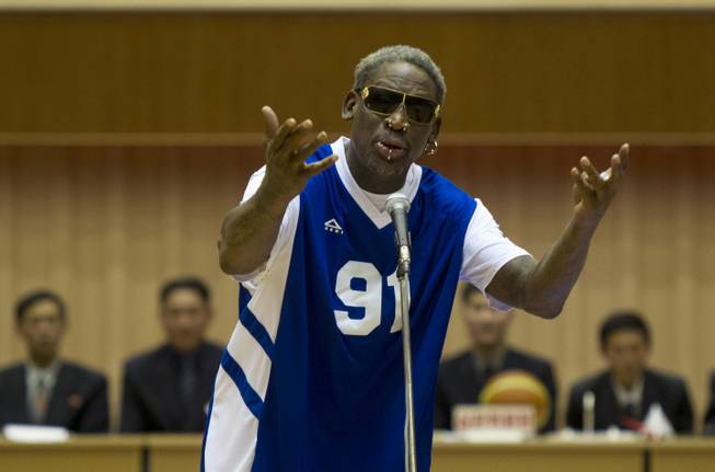 Dennis Rodman sings Happy Birthday to North Korean leader Kim Jong Un, seated above in the stands, before an exhibition basketball game at an indoor stadium in Pyongyang, North Korea on Wednesday, Jan. 8, 2014.