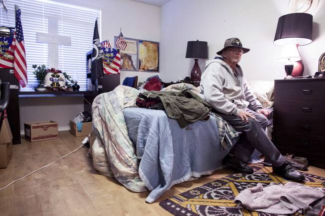 George Reimiller keeps a shrine in his studio apartment for his fellow veterans, including a brother who died in Vietnam, at Victory Place, a community for former servicemen in Phoenix, Jan. 8, 2014.