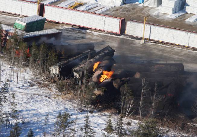 This aerial photo shows derailed train cars burning in Plaster Rock, New Brunswick on Wednesday, Jan. 8, 2014. A Canadian National Railway freight train carrying crude oil and propane derailed Tuesday night in a sparsely populated region of northwestern New Brunswick. More than 100 residents remained evacuated from their homes. There were no deaths or injuries.