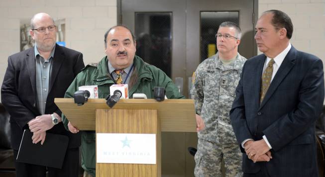 Jimmy Gianato, the director of the West Virginia Department of Homeland Security, at podium, addresses reporters during a press conference about the regional water contamination late Thursday, Jan. 9, 2014.  in Charleston, W.Va.  With him are West Virginia American Water President Jeff McIntyre,left,  West Virginia National Guard Adj. Gen. James Hoyer and Governor Earl Ray Tomblin, right.