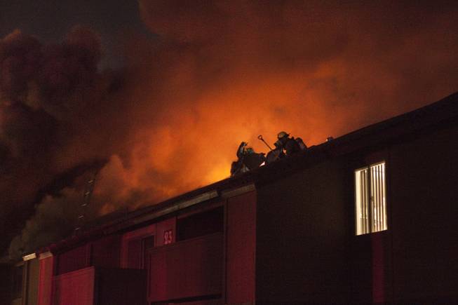 Firefighters on the roof of Century Village apartments, 4801 Spencer St., early Thursday Jan. 9, 2014.