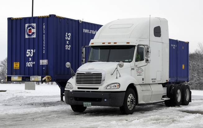 This is the tractor trailer under which Tim Rutledge, 53, of Orlando, Fla., says he crawled before dawn Monday to fix its frozen brakes when it suddenly settled deeper into the snow, pinning him beneath an axle. It remains at a truck stop in Whiteland, Ind., Thursday, Jan. 9, 2014. 