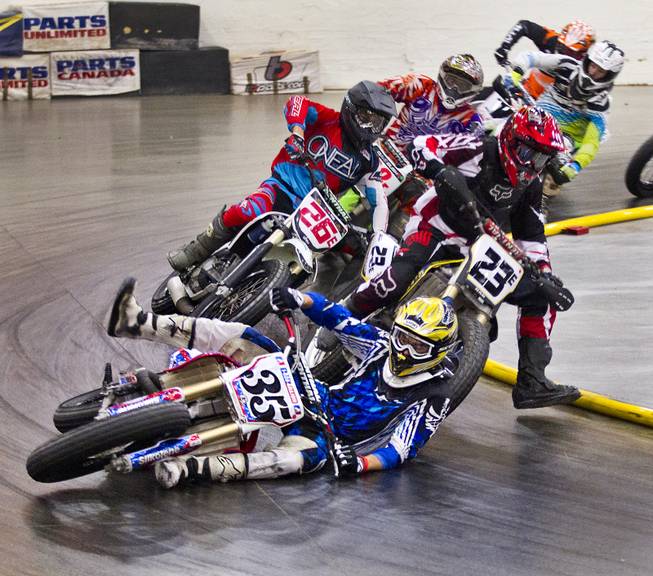 Rider Brady Mueller (35) goes down and loses first place in the Open Class final of the West Coast Flat Track Series Races starting on Friday, Jan. 10, 2014.