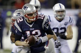 New England Patriots quarterback Tom Brady turns out of the pocket during the second half of an AFC divisional NFL playoff football game against the Indianapolis Colts in Foxborough, Mass., Saturday, Jan. 11, 2014. (AP Photo/Stephan Savoia)
