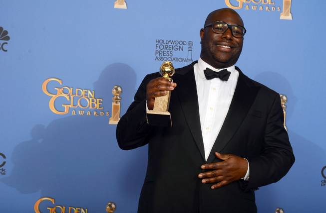 Steve McQueen poses in the press room with the award for best motion picture - drama for "12 Years a Slave" at the 71st annual Golden Globe Awards at the Beverly Hilton Hotel on Sunday, Jan. 12, 2014, in Beverly Hills, Calif. 