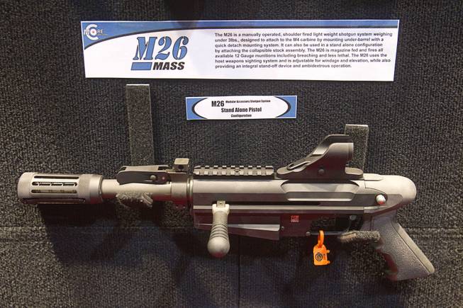 An M26 shotgun pistol is displayed at the C-More booth during the 2014 SHOT Show (Shooting, Hunting, Outdoor Trade) at the Sands Expo & Convention Center Tuesday, Jan. 14, 2014. The gun is designed to attach under the barrel of a M4 carbine.