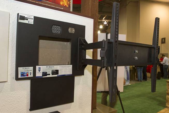 A Cannon Security products gun safe is shown behind a flat panel television wall mount during the 2014 SHOT Show (Shooting, Hunting, Outdoor Trade) at the Sands Expo & Convention Center Tuesday, Jan. 14, 2014. The safe retails for $349.00.