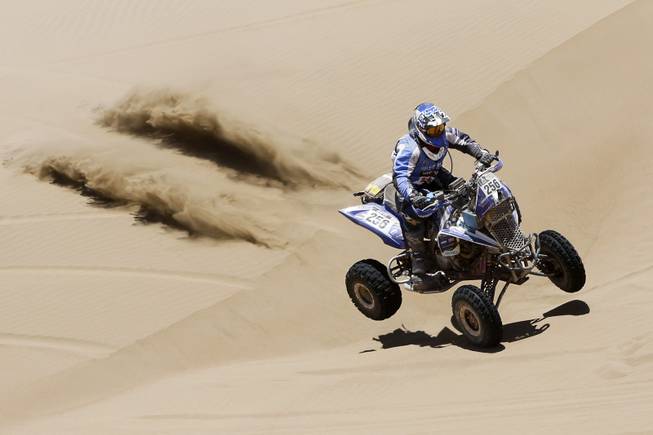 Yamaha rider Sergio Lafuente, of Uruguay, races across the dunes during the ninth stage of the Dakar Rally between the cities of Calama and Iquique, Chile, Tuesday, Jan. 14, 2014. 