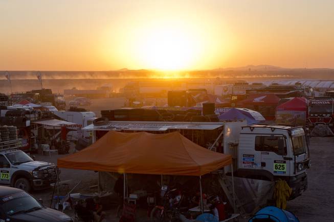 The sun sets behind the Dakar Rally camp in Calama, Chile, Monday, Jan. 13, 2014. The Dakar Rally will finish on Jan. 18 in Valparaiso, Chile. 