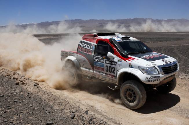 Toyota driver Giniel de Villiers of South Africa and co-pilot Dirk Von Zitzewitz of Germany race during the eight stage of the Dakar Rally between the cities of Salta, Argentina, and Calama, Chile, Monday, Jan. 13, 2014. 