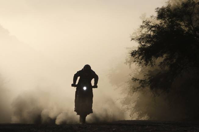 Juan Carlos Salvatierra, from Bolivia, races his Speedbrain motorcycle during the Dakar Rally between the cities of San Miguel de Tucuman and Salta, Argentina, Friday, Jan. 10, 2014. 
