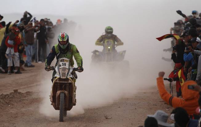 KTM rider Brett Cummings of South Africa, left, and Yamaha rider Ignacio Casale of Chile race during the seventh stage of the Dakar Rally between the cities of Salta, Argentina and Uyuni, Bolivia, Sunday, Jan. 12, 2014. 
