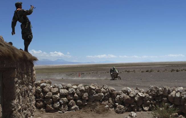 KTM rider Brett Cummings of South Africa races during the eighth stage of the Dakar Rally between the cities Uyuni, Bolivia and Calama, Chile in Kui, Bolivia, Monday, Jan. 13, 2014. 