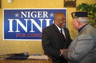 Republican Niger Innis, left, talks with Ret. Air Force Col. Bob Frank after announcing he is running for Congress at Leticia's Cocina, a Mexican restaurant near Highway 95 and Durango Dr., Wednesday, Jan. 15, 2014. Innis will challenge Democrat Steven Horsford for the seat.