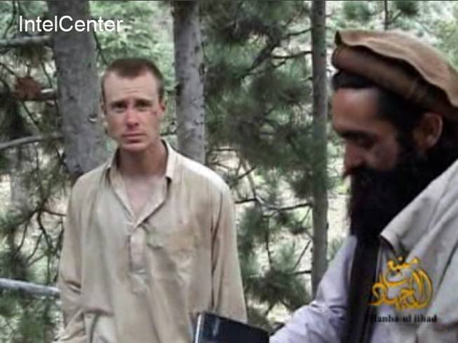 This file image provided by IntelCenter on Wednesday Dec. 8, 2010, shows a framegrab from a video released by the Taliban containing footage of a man believed to be Sgt. Bowe Bergdahl, left.