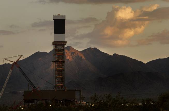 The sun sets behind one of three Solar Receivers at BrightSource Energy&apos;s Ivanpah Solar Electric Generating Station (ISEGS) in California&apos;s Ivanpah Valley, just miles south of the Nevada state line Aug. 8, 2012.