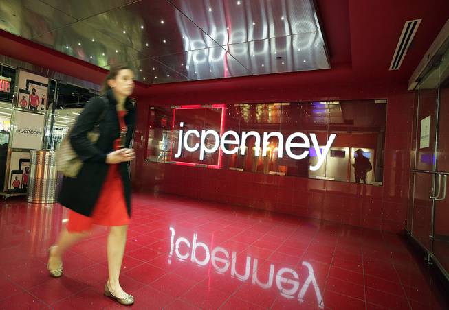In this April 9, 2013 file photo, a customer leaves a J.C. Penney store in New York. J.C. Penney on Wednesday, Jan. 15, 2014 announced it will cut 2,000 jobs and close 33 stores as it tries to get back on the path to profitability. 