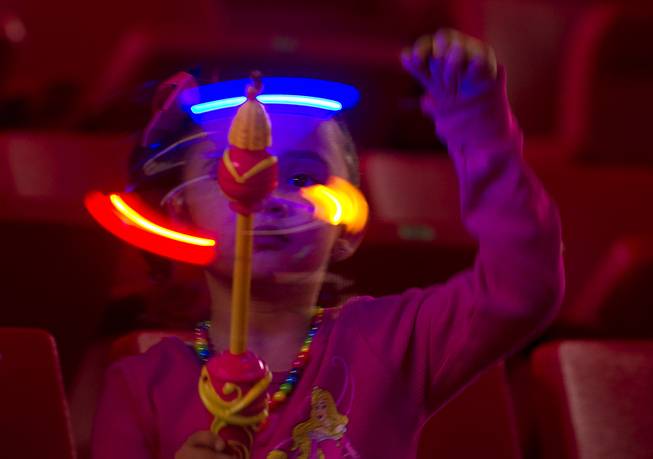 Olivia Alvarado, 3, plays with a spinning toy as she waits for the start of "Disney On Ice: Rockin' Ever After" at the Thomas & Mack Center Thursday, Jan. 16, 2014. The show plays at the center through Sunday.