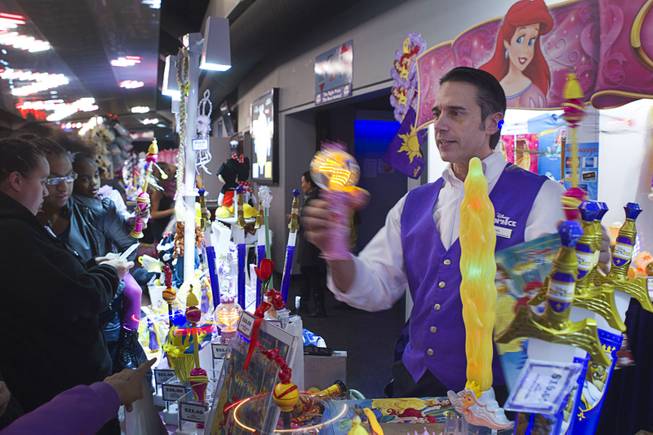 Darren Maiale sells Disney merchandise and spinning toys before the "Disney On Ice: Rockin' Ever After" show at the Thomas & Mack Center Thursday, Jan. 16, 2014. The show plays at the center through Sunday.
