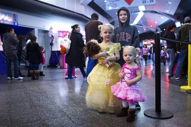 Summer Breeze Morrison, 5, and Taylor Rayne Morrison, 18-months, pose in their princess dresses with their brother Brian Keith, 9,  before "Disney On Ice: Rockin' Ever After" at the Thomas & Mack Center Thursday, Jan. 16, 2014. The show plays at the center through Sunday.
